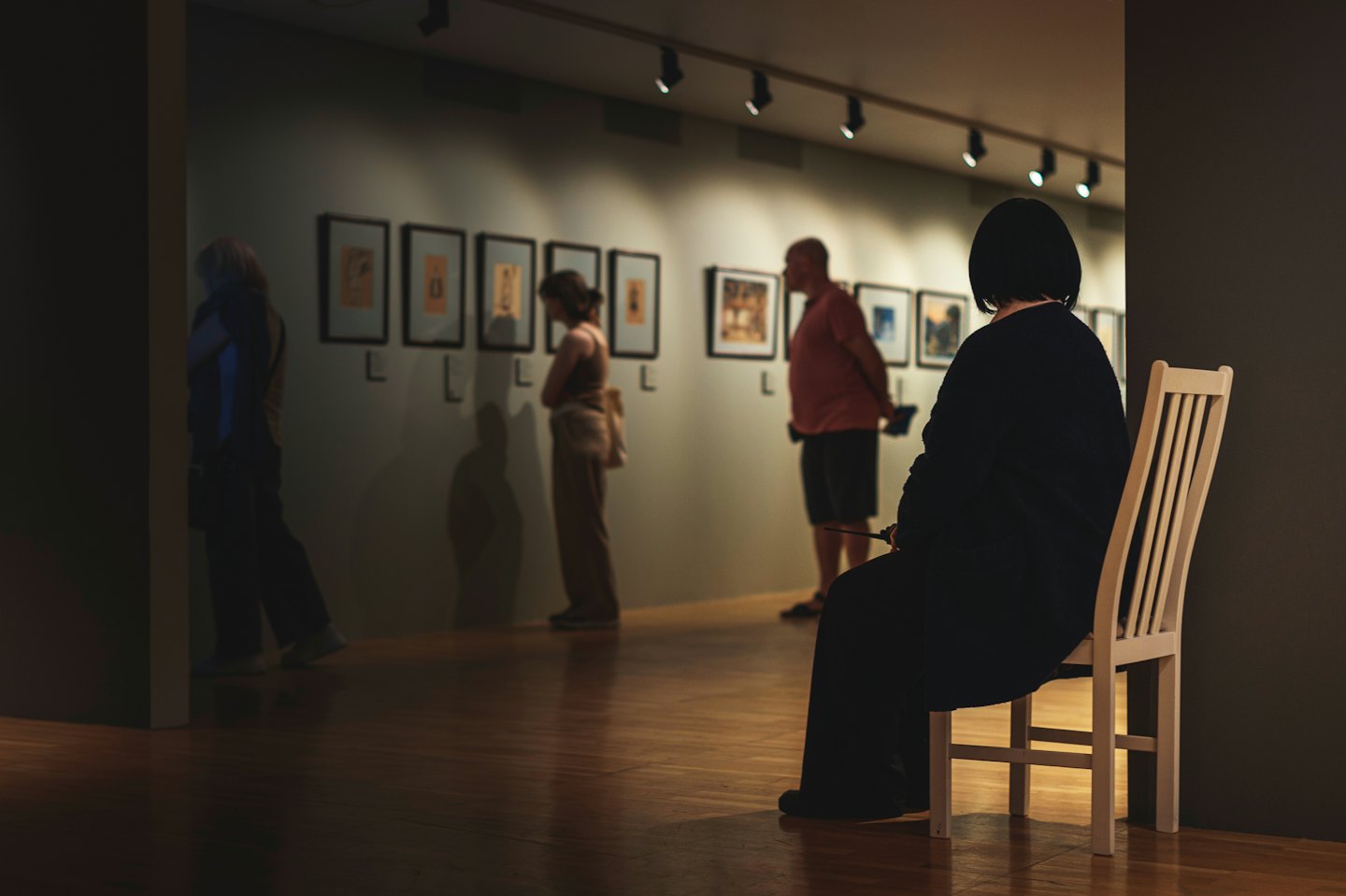 People viewing art in a modern gallery.
