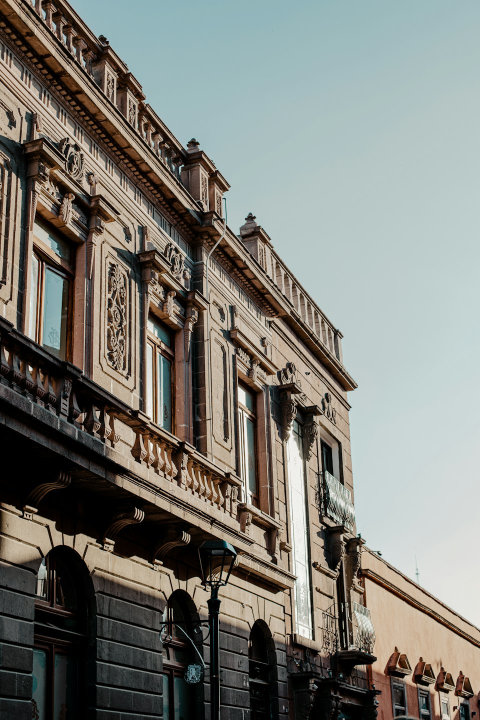 Ornate historic stone building with a vintage streetlamp.